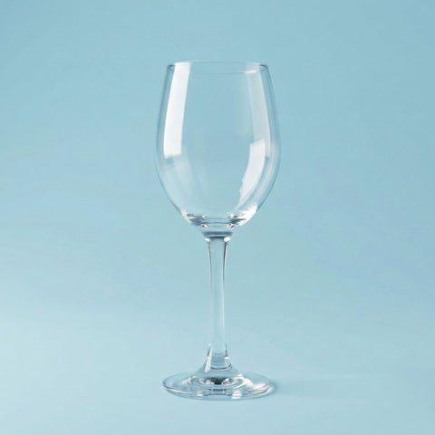 Clear wine glass on a light blue background