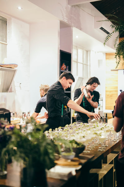 Bar tenders making cocktails at an event