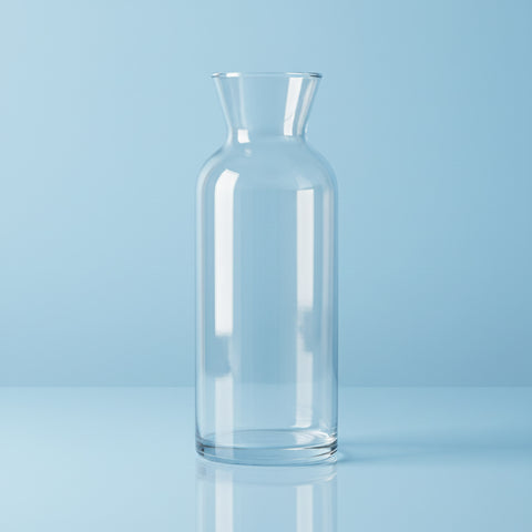 Clear glass carafe on a light blue background