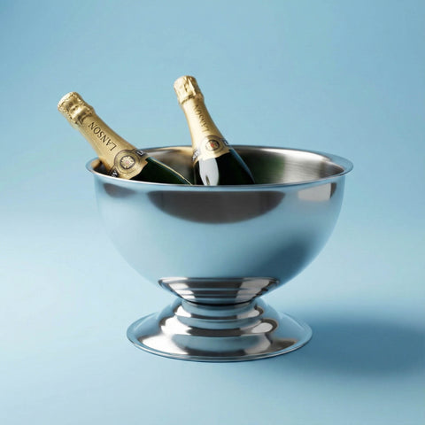 Two champagne bottles in a stainless steel champagne bowl against a light blue background