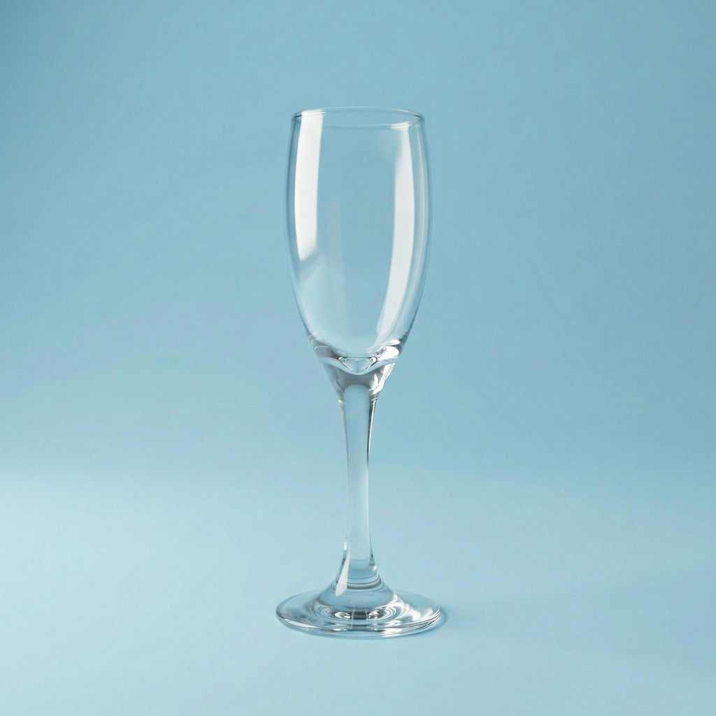 Clear champagne flute glass on a light blue background
