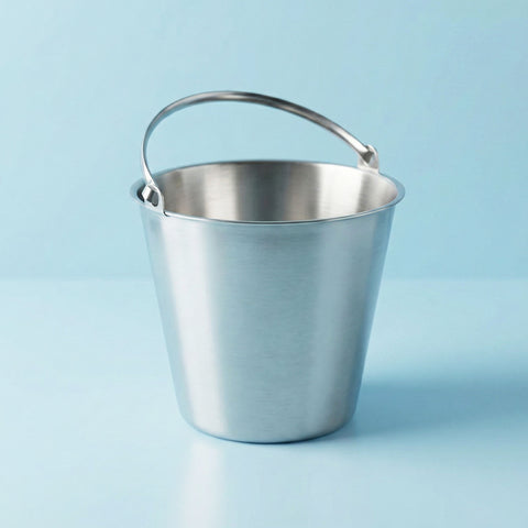 Stainless steel champagne bucket on a light blue background