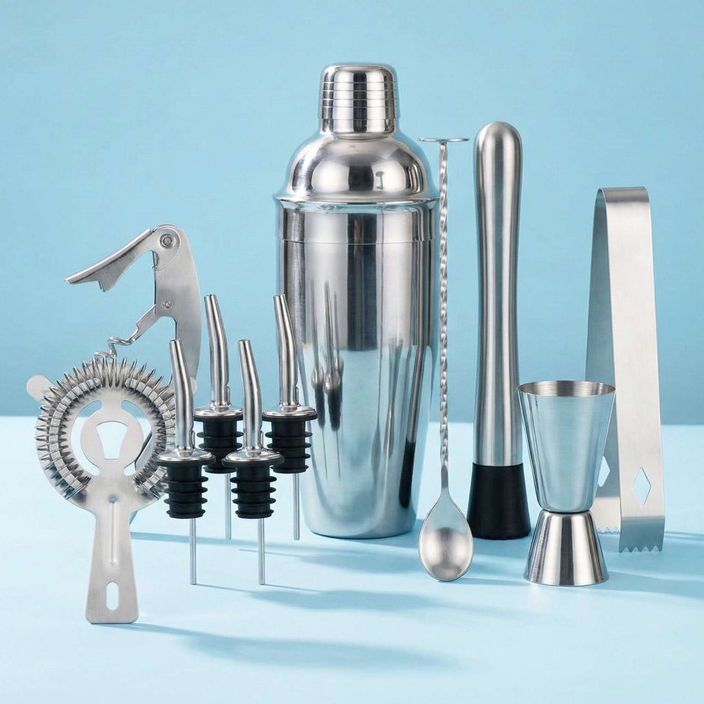 Set of cocktail-making tools including a shaker, jigger, strainer, and other utensils on a light blue background.
