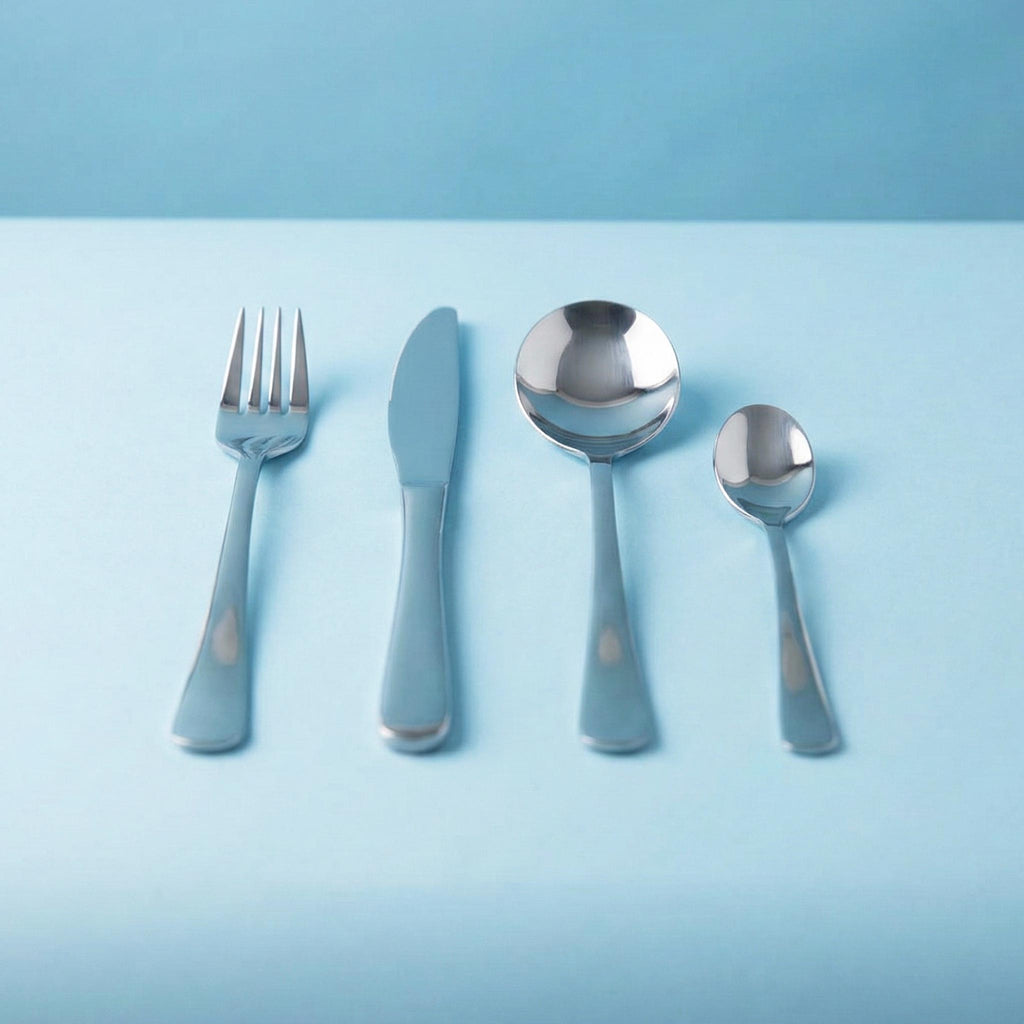 Set of silver cutlery with blue handles on a light blue background