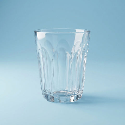 Clear glass latte tumbler on a light blue background