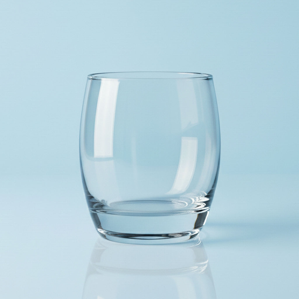 Clear glass tumbler on a light blue background
