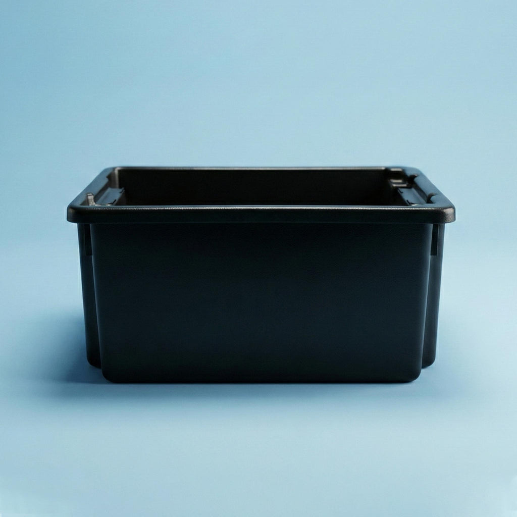 Black rectangular plastic butchers drinks tub on a light blue background