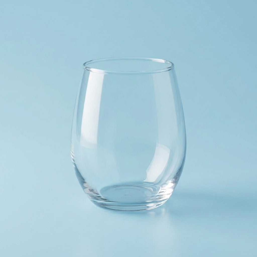 Clear glass tumbler on a light blue background