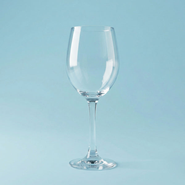 Clear wine glass on a light blue background