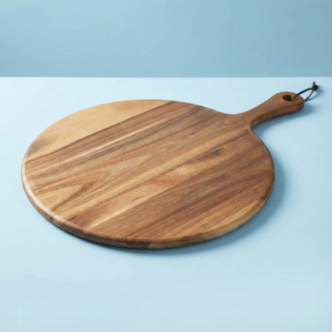 Wooden serving board on a light blue background